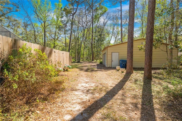 view of yard with an outdoor structure and fence