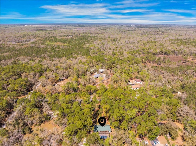 drone / aerial view featuring a forest view