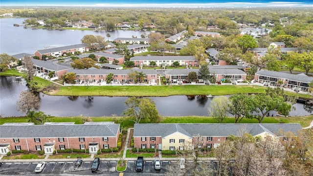 drone / aerial view featuring a residential view and a water view