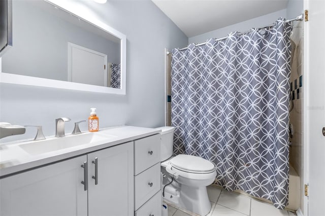 bathroom featuring vanity, toilet, and tile patterned flooring