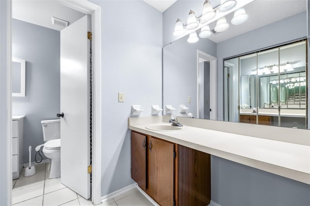 bathroom with vanity, tile patterned floors, toilet, and visible vents