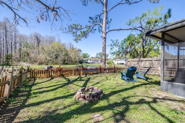 view of yard with a fire pit and a fenced backyard