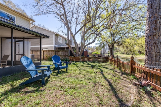 view of yard with a fenced backyard and a sunroom