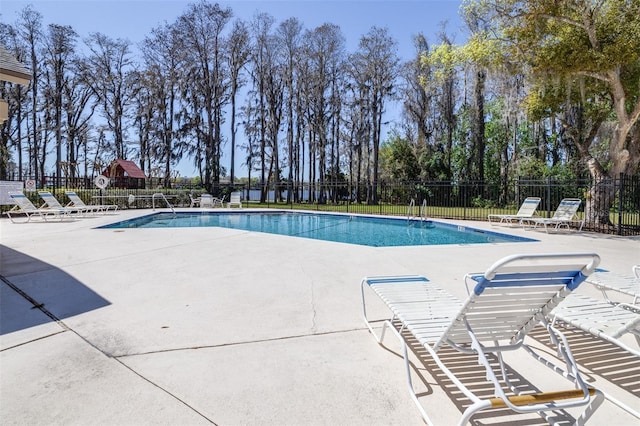 community pool featuring a patio and fence