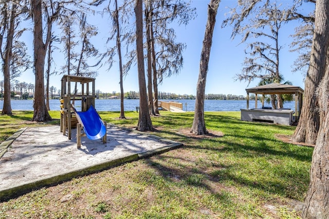 view of yard with a playground and a water view