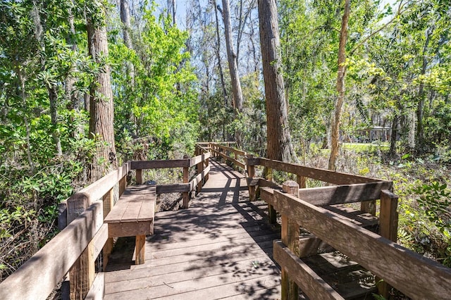 wooden terrace featuring a view of trees