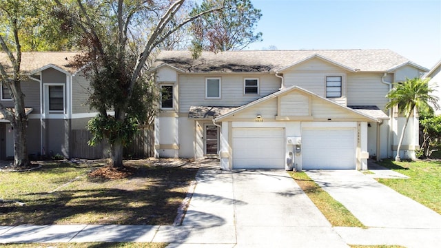 view of front of property featuring concrete driveway, a front lawn, and fence