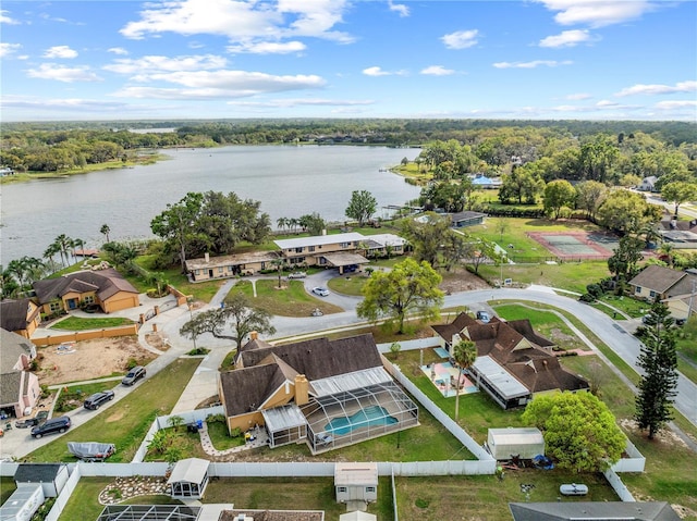 drone / aerial view featuring a view of trees and a water view