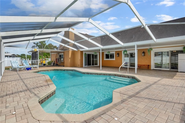 pool with glass enclosure and a patio