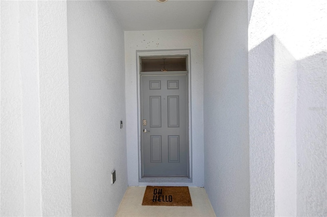 doorway to property with stucco siding