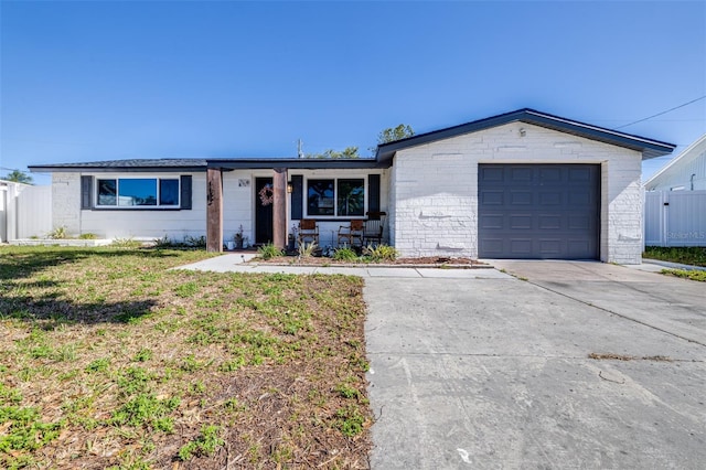 single story home with driveway, a front yard, an attached garage, and fence