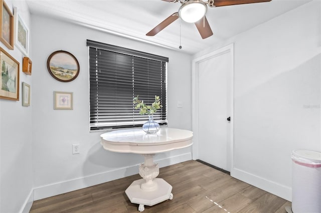 bathroom with ceiling fan, baseboards, and wood finished floors