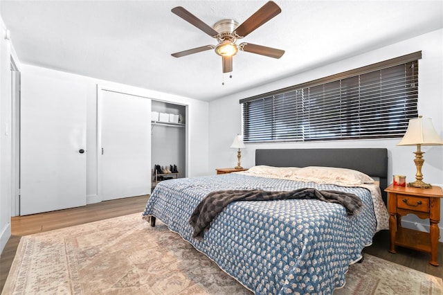 bedroom featuring a closet, a ceiling fan, and wood finished floors