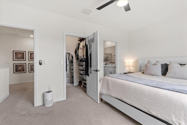 33064 Tulip Petal Ln, Wesley Chapel, FL 33545 - bedroom featuring light carpet, a spacious closet, a closet, and ensuite bath