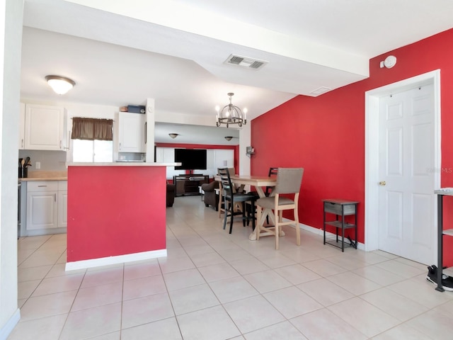 kitchen featuring light tile patterned floors, visible vents, light countertops, white cabinetry, and a notable chandelier