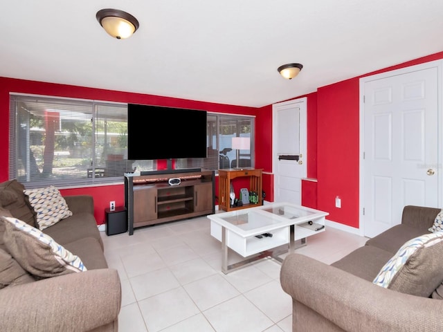 living area featuring tile patterned floors and baseboards