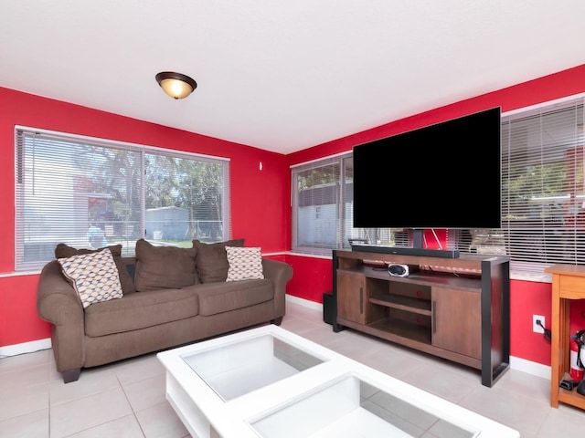 living area featuring light tile patterned floors and baseboards