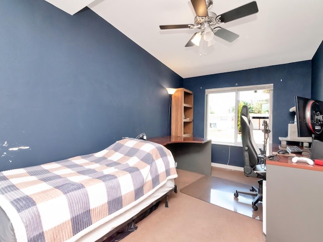 bedroom featuring ceiling fan and an accent wall