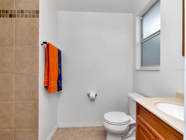 bathroom with vanity, tile patterned floors, toilet, and baseboards