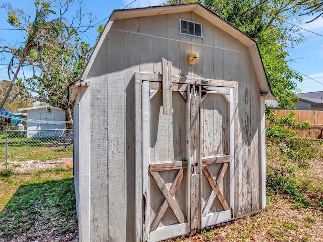 view of shed with fence