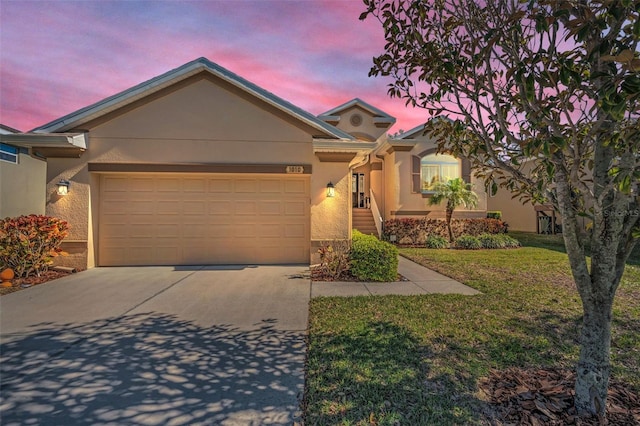 single story home featuring a garage, stucco siding, concrete driveway, and a front yard