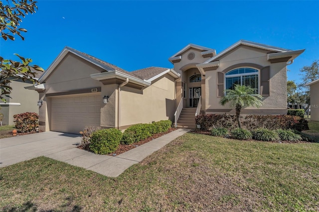 view of front of property featuring a front lawn, an attached garage, concrete driveway, and stucco siding