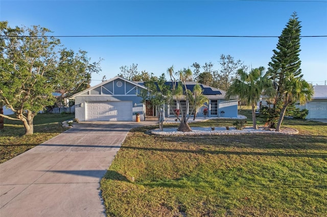 ranch-style home featuring a front lawn, driveway, a garage, and roof mounted solar panels