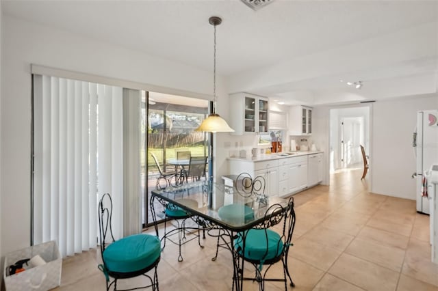 dining room featuring light tile patterned floors and visible vents