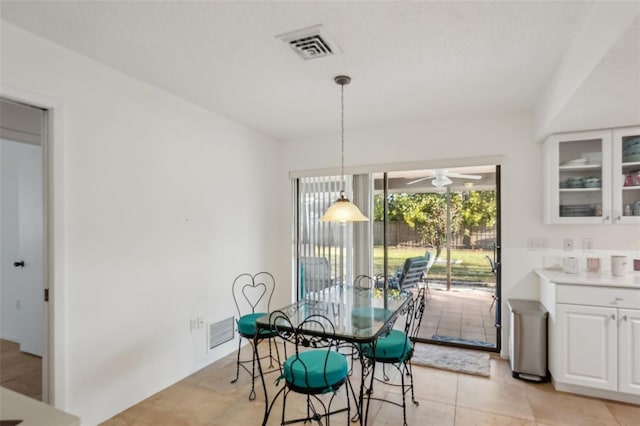 dining room with light tile patterned floors, visible vents, and ceiling fan