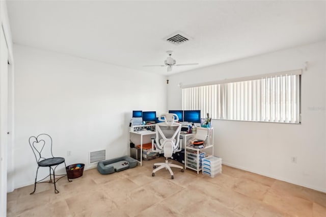 office space with visible vents and a ceiling fan