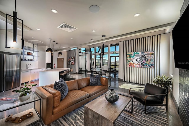 living area with visible vents and recessed lighting