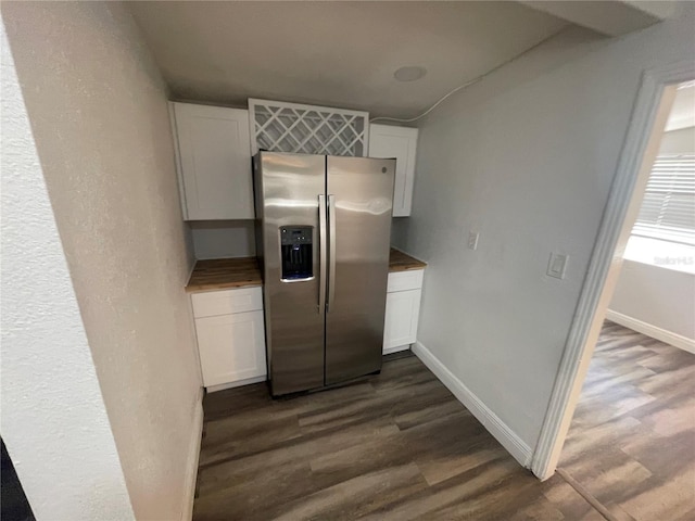 645 38th Ave S, Saint Petersburg, FL 33705 - kitchen featuring baseboards, dark wood finished floors, stainless steel refrigerator with ice dispenser, and white cabinetry