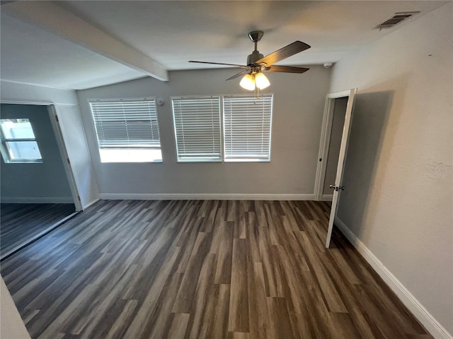 645 38th Ave S, Saint Petersburg, FL 33705 - spare room featuring visible vents, vaulted ceiling with beams, ceiling fan, baseboards, and dark wood-style floors