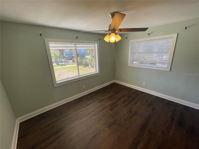 645 38th Ave S, Saint Petersburg, FL 33705 - unfurnished room with a ceiling fan, baseboards, and dark wood-style flooring