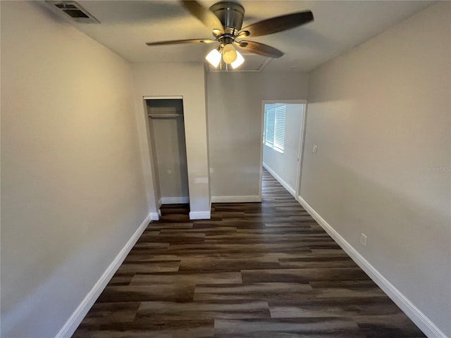645 38th Ave S, Saint Petersburg, FL 33705 - unfurnished bedroom with visible vents, baseboards, dark wood finished floors, a closet, and a ceiling fan