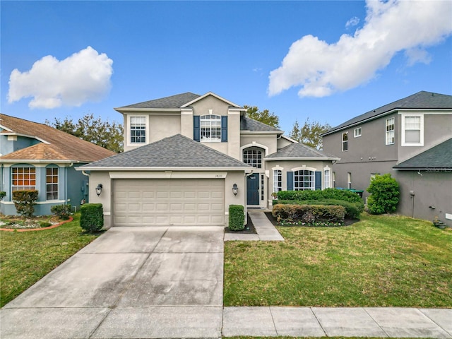 traditional-style house featuring stucco siding, concrete driveway, a front yard, a shingled roof, and a garage