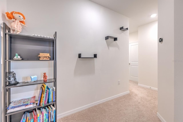 corridor with carpet flooring and baseboards