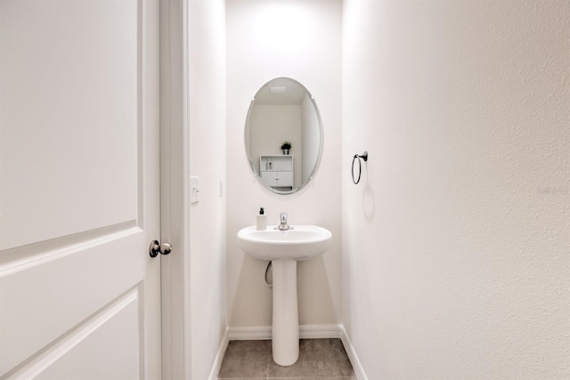 bathroom with tile patterned floors and baseboards