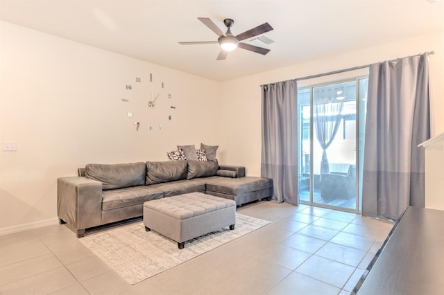 living area with light tile patterned floors, baseboards, visible vents, and ceiling fan