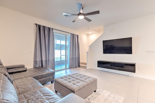 tiled living area featuring visible vents, baseboards, and ceiling fan