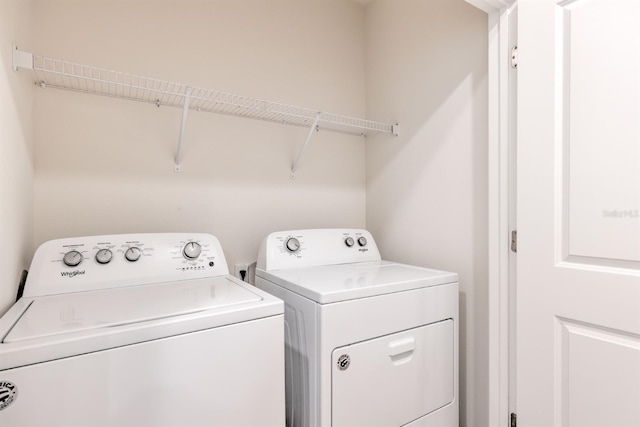 washroom featuring washer and dryer and laundry area