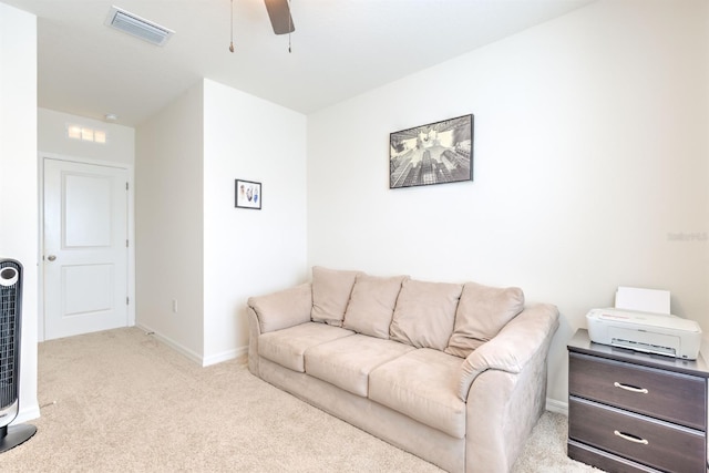 living room featuring baseboards, visible vents, a ceiling fan, and carpet