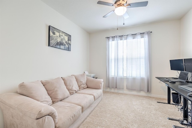 carpeted living area featuring ceiling fan