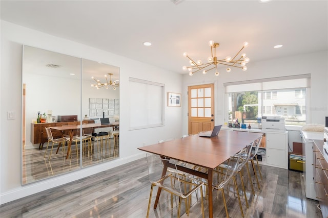 dining area featuring visible vents, a notable chandelier, wood finished floors, recessed lighting, and baseboards