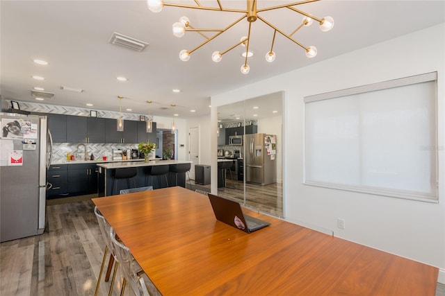 dining space featuring recessed lighting, visible vents, and wood finished floors