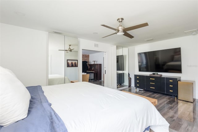 bedroom with visible vents, ceiling fan, and wood finished floors