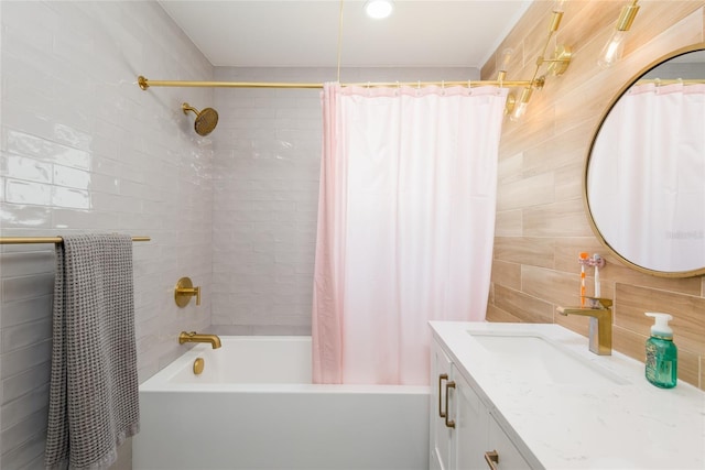 bathroom featuring shower / bath combination with curtain, vanity, and tile walls