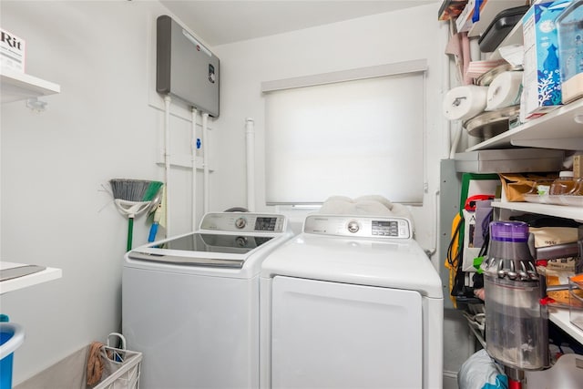 laundry room featuring separate washer and dryer and laundry area