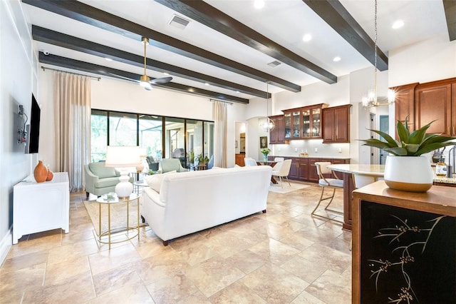 living area with beamed ceiling, visible vents, a notable chandelier, recessed lighting, and arched walkways