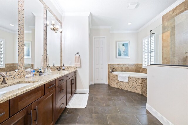 bathroom featuring a garden tub, ornamental molding, tile patterned floors, and a sink